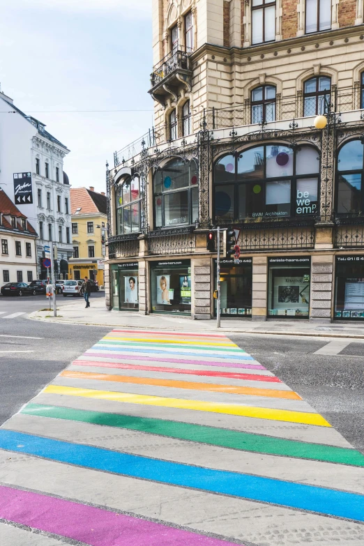 a rainbow painted street in a town center