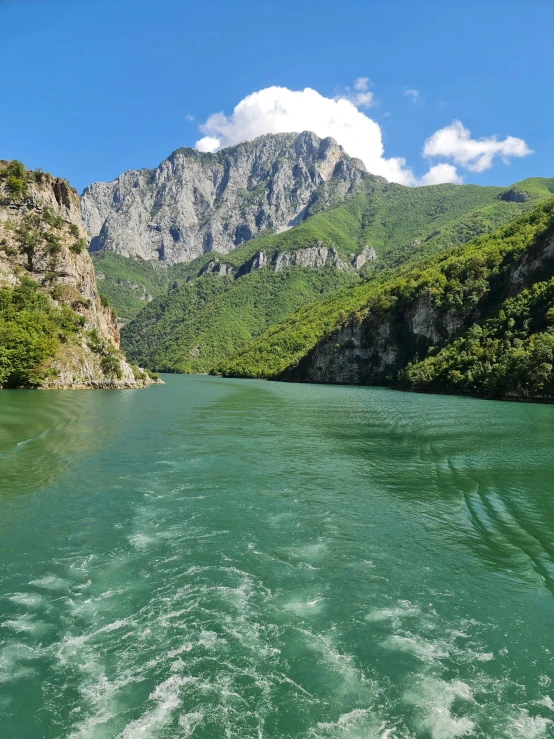 a large body of water that is near a rocky area