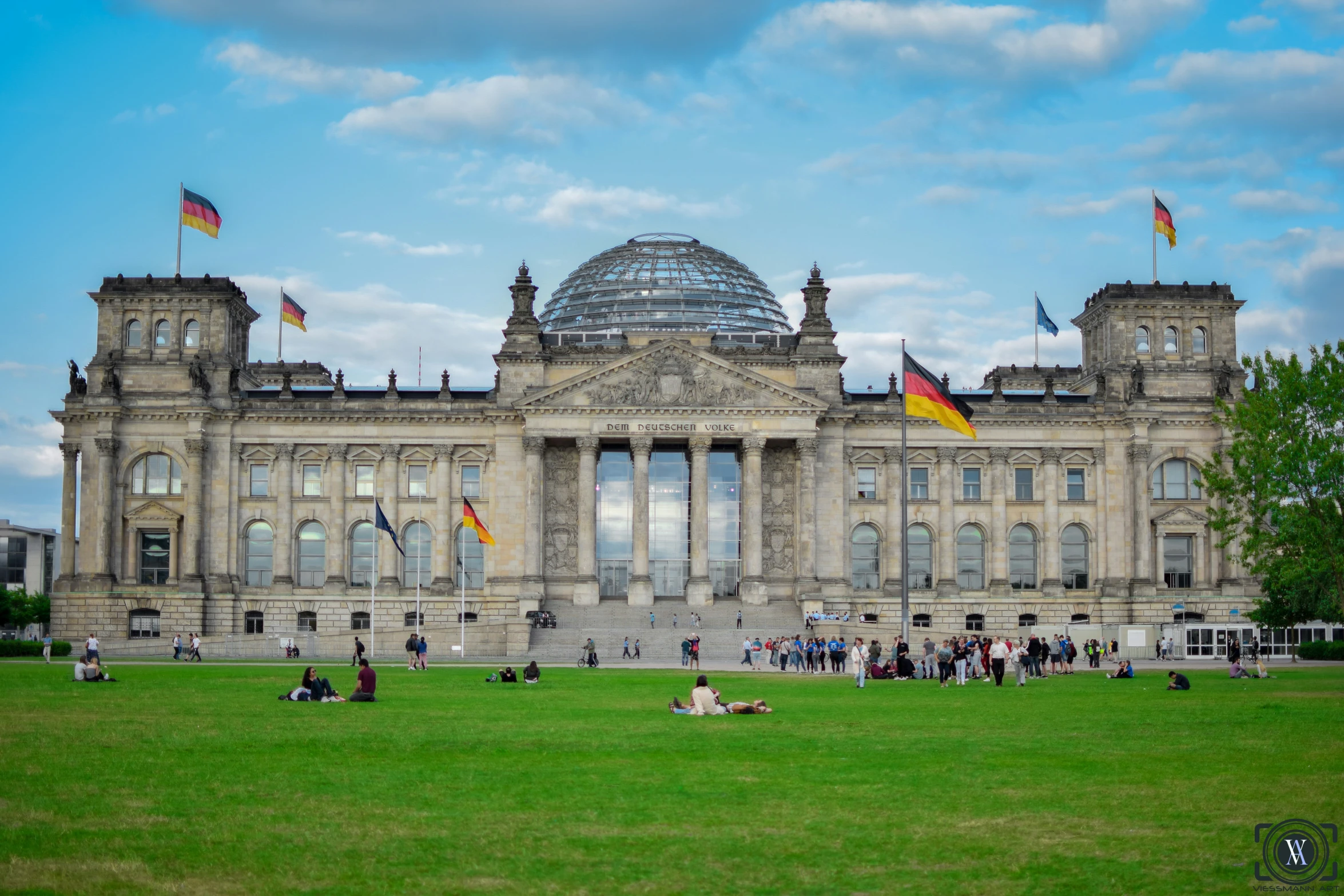 the large building has many flags on it