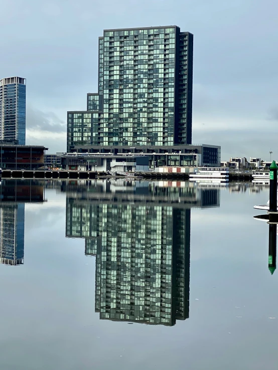 a city with skyscrs and boats in the water