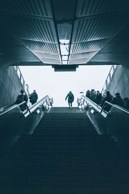 a man walking down the stairs towards another person