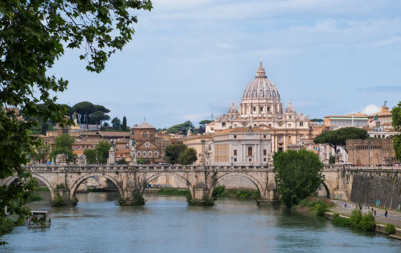 an old bridge crosses over the water in the city