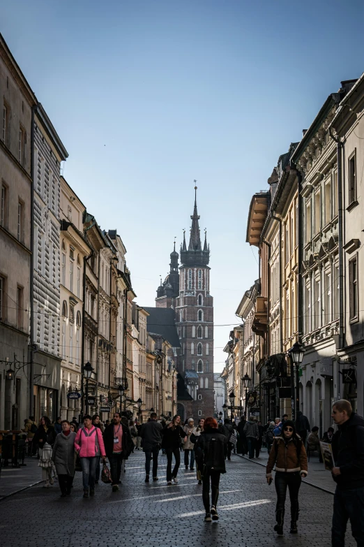 people walk on an old city street,