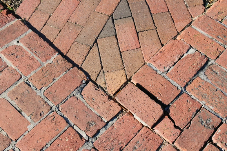 there is a small red brick sidewalk next to the grass