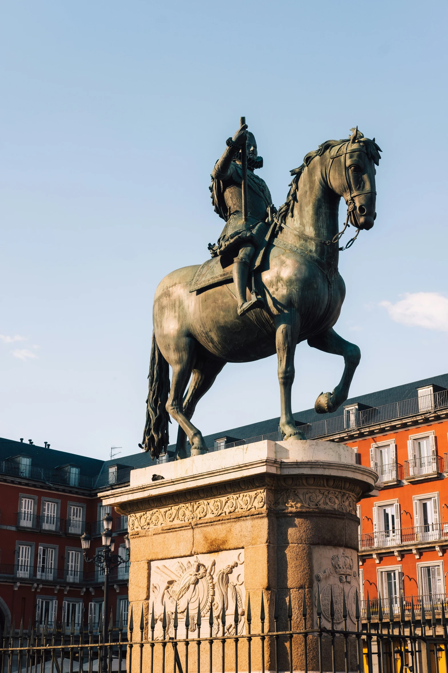 a statue of a man on horseback sits on top of a monument