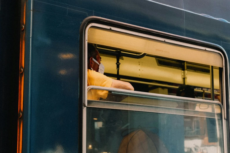 the corner of a train with someone holding a stuffed animal