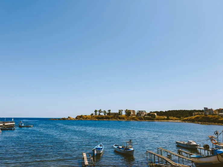 boats are in the harbor on an azure day