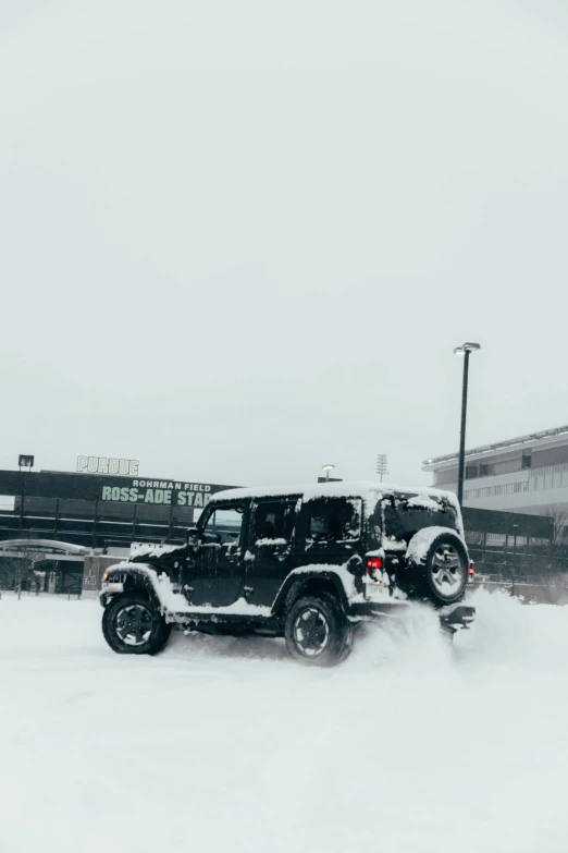 a jeep is driving through the snow on a race track