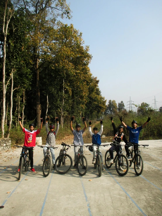 children ride on bicycles together in a line