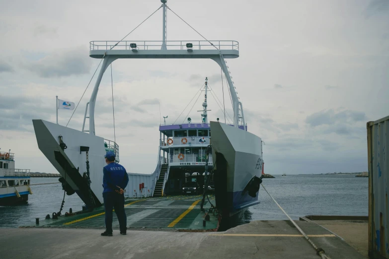 a boat being loaded onto the dock by a worker