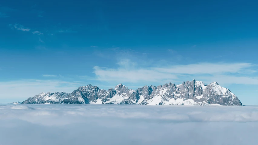 the view from behind the mountain tops in the cloud