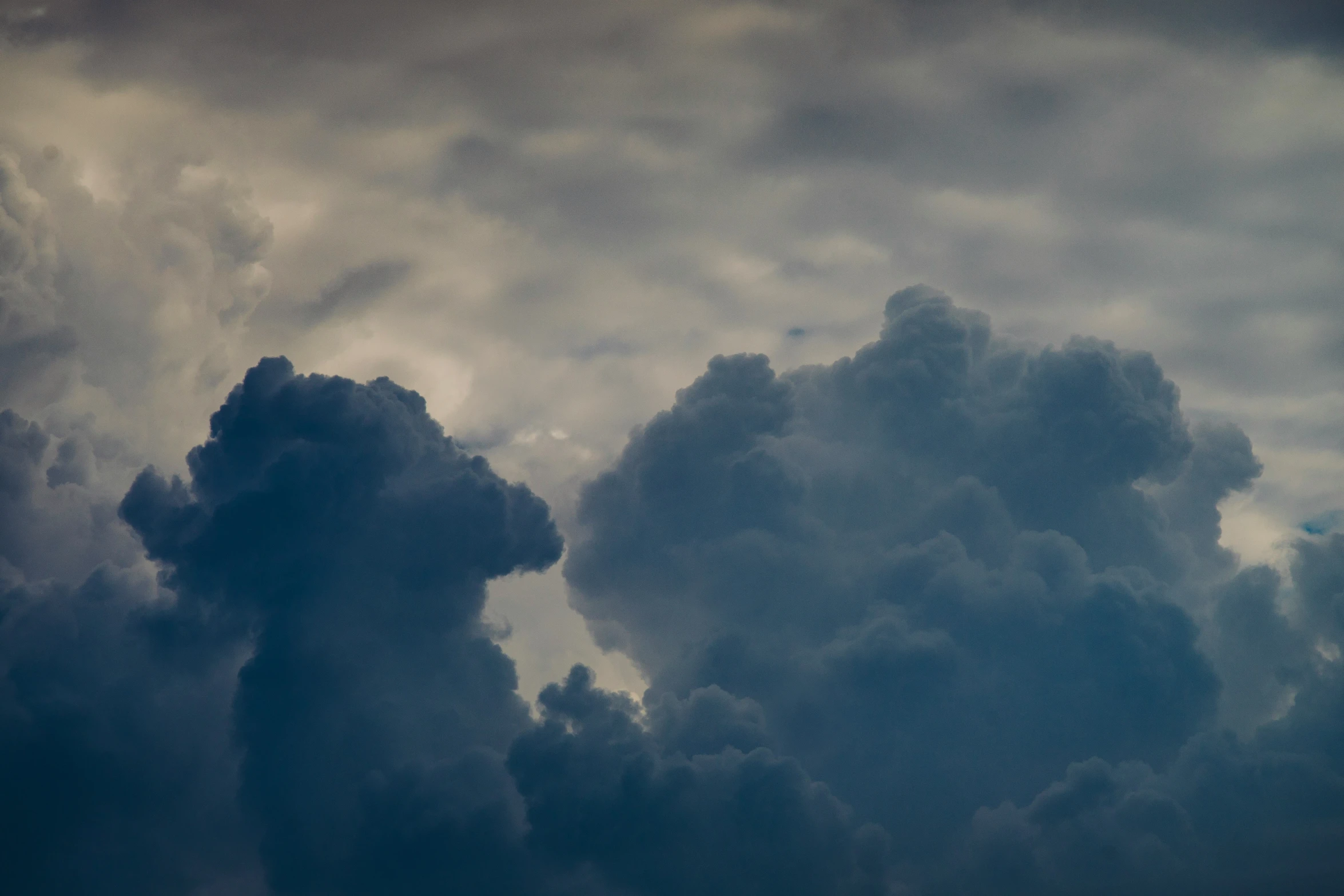 a large jetliner flying through a cloudy sky