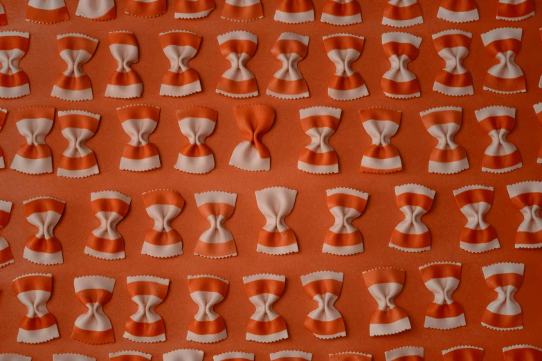 a bunch of orange and white decorative pieces