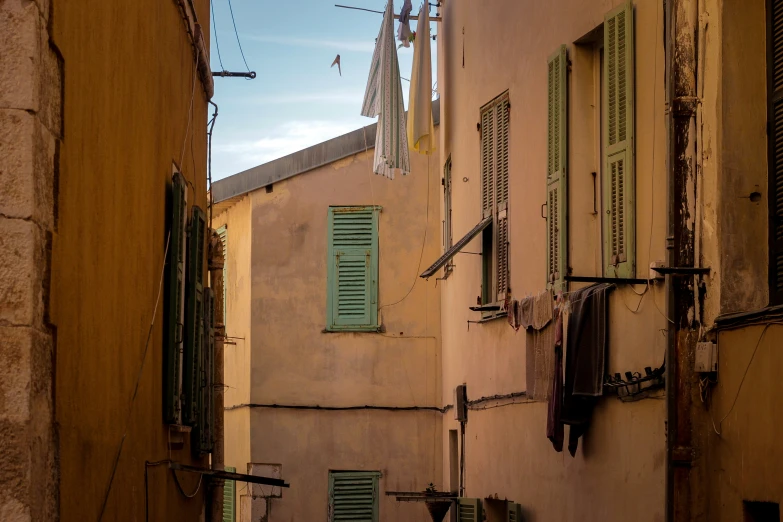 the narrow streets are lined with windows and closed shutters