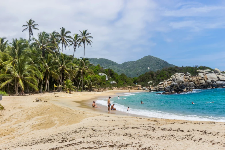 a beach with people walking on it