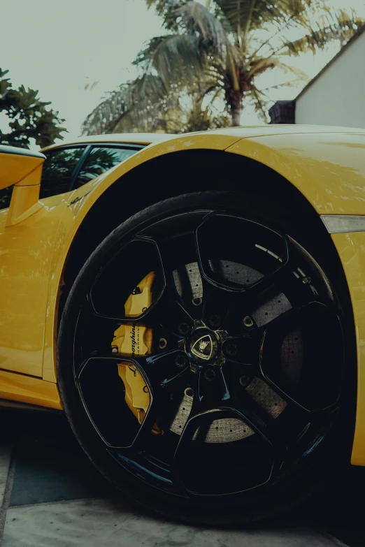 the front tire of a yellow sport car