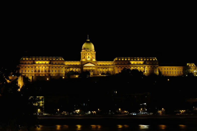 the parliament building is lit up in a dark night