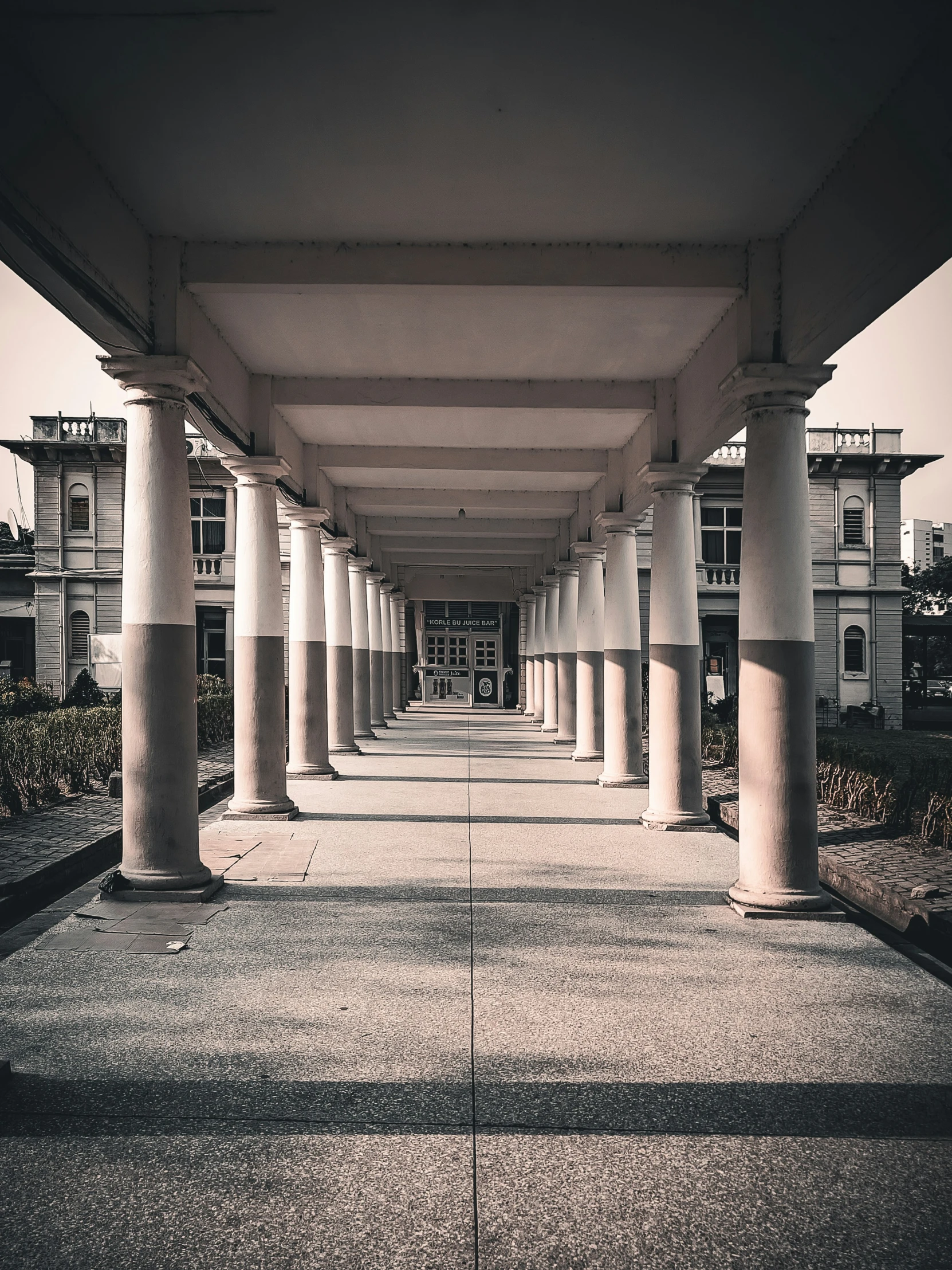 a picture looking down a walkway between buildings