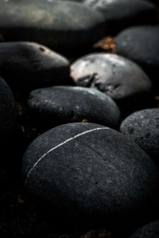 large boulders all piled together and some have white lines on them