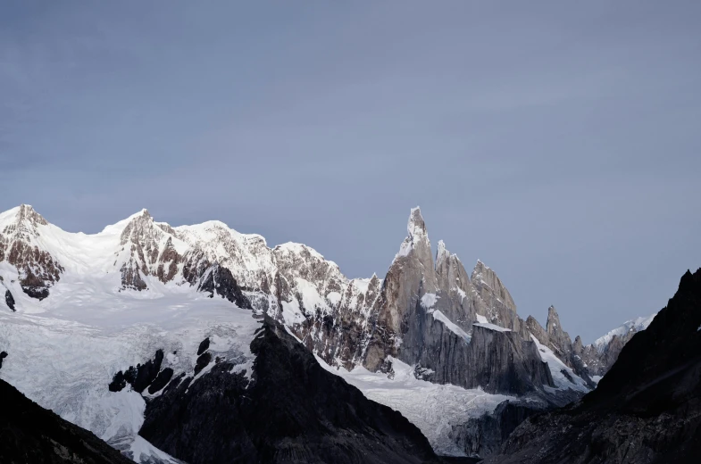 some very nice looking snow covered mountains under a blue sky