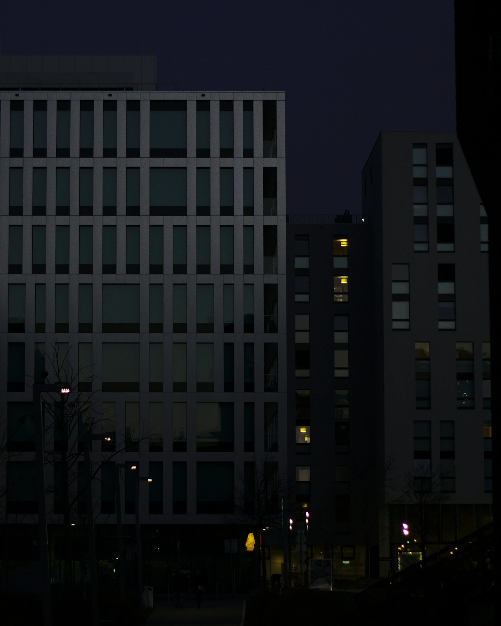 a dark city at night with a building in the distance