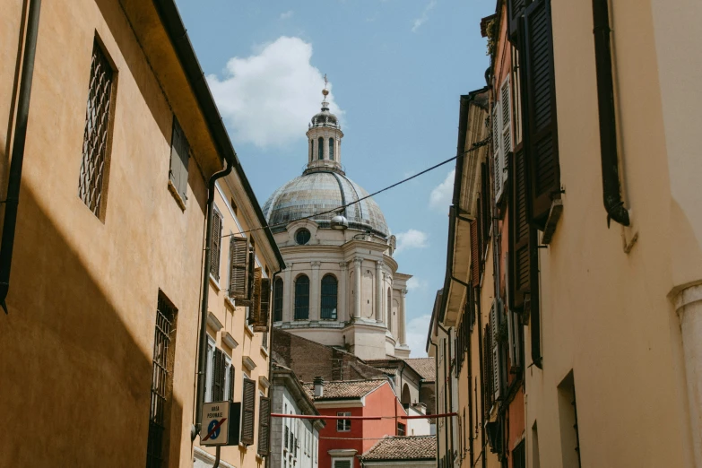 a view down a narrow cobblestone street from the side