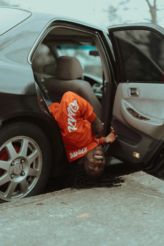 a young child is attempting to climb into a car