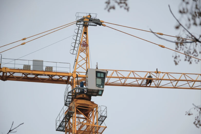 a tower crane with various construction equipment around it