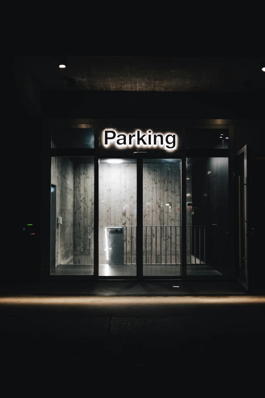 a parking sign hanging above the doorway to a store