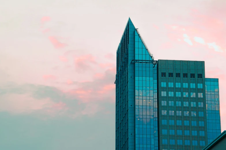 a sky filled with clouds next to some building