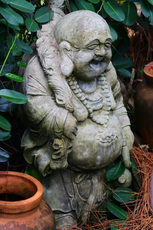 an asian statue has his head inside of him