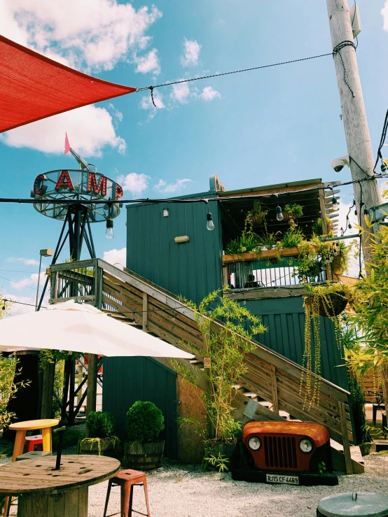 a red car sits parked next to a green house