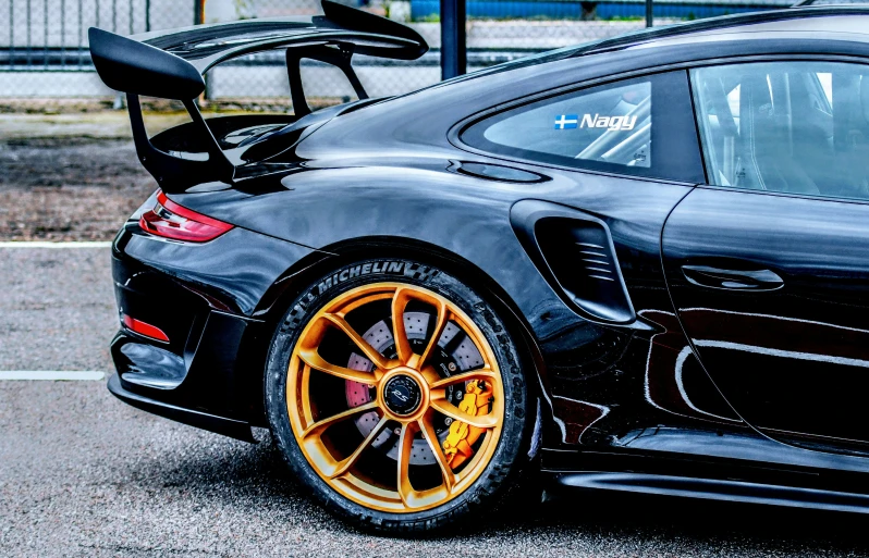 a black sports car with orange and yellow accents