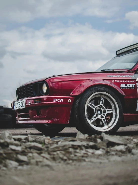 an extremely clean, red car sitting in the road