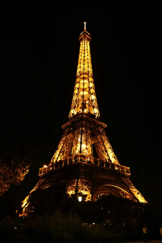 the eiffel tower lit up in the night sky