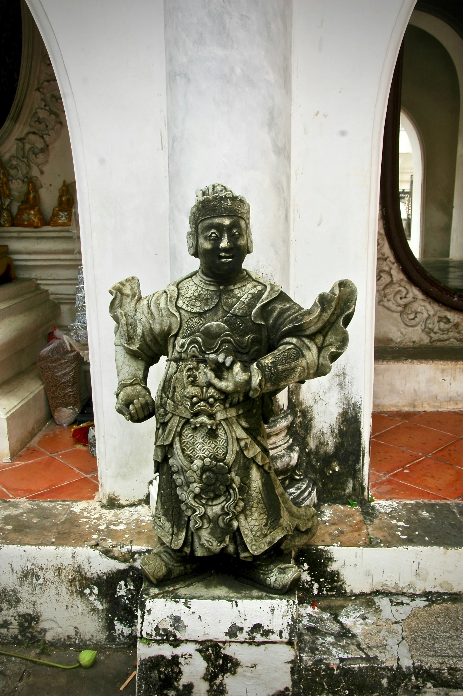 a statue of an asian warrior surrounded by other statues