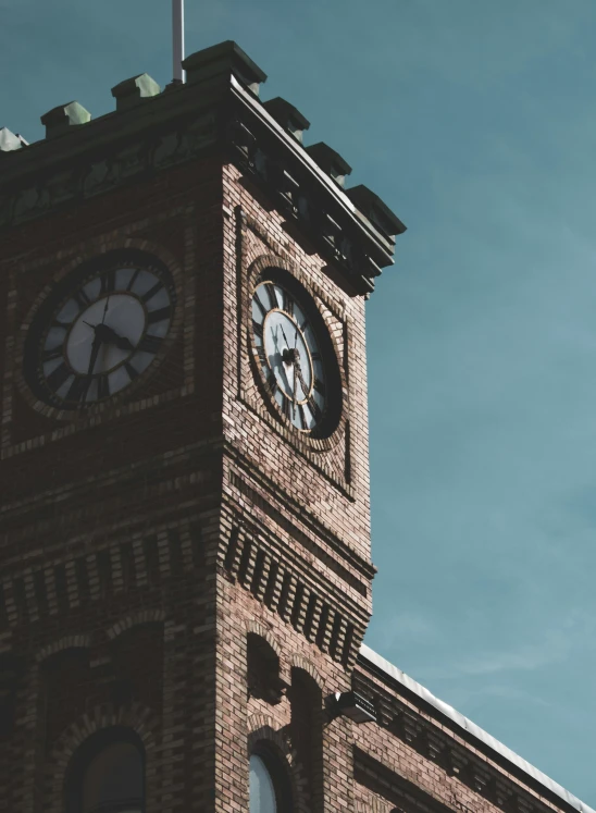 an old clock tower in the daytime with a blue sky