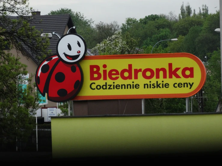 a sign for the company biedronka with a ladybug on it