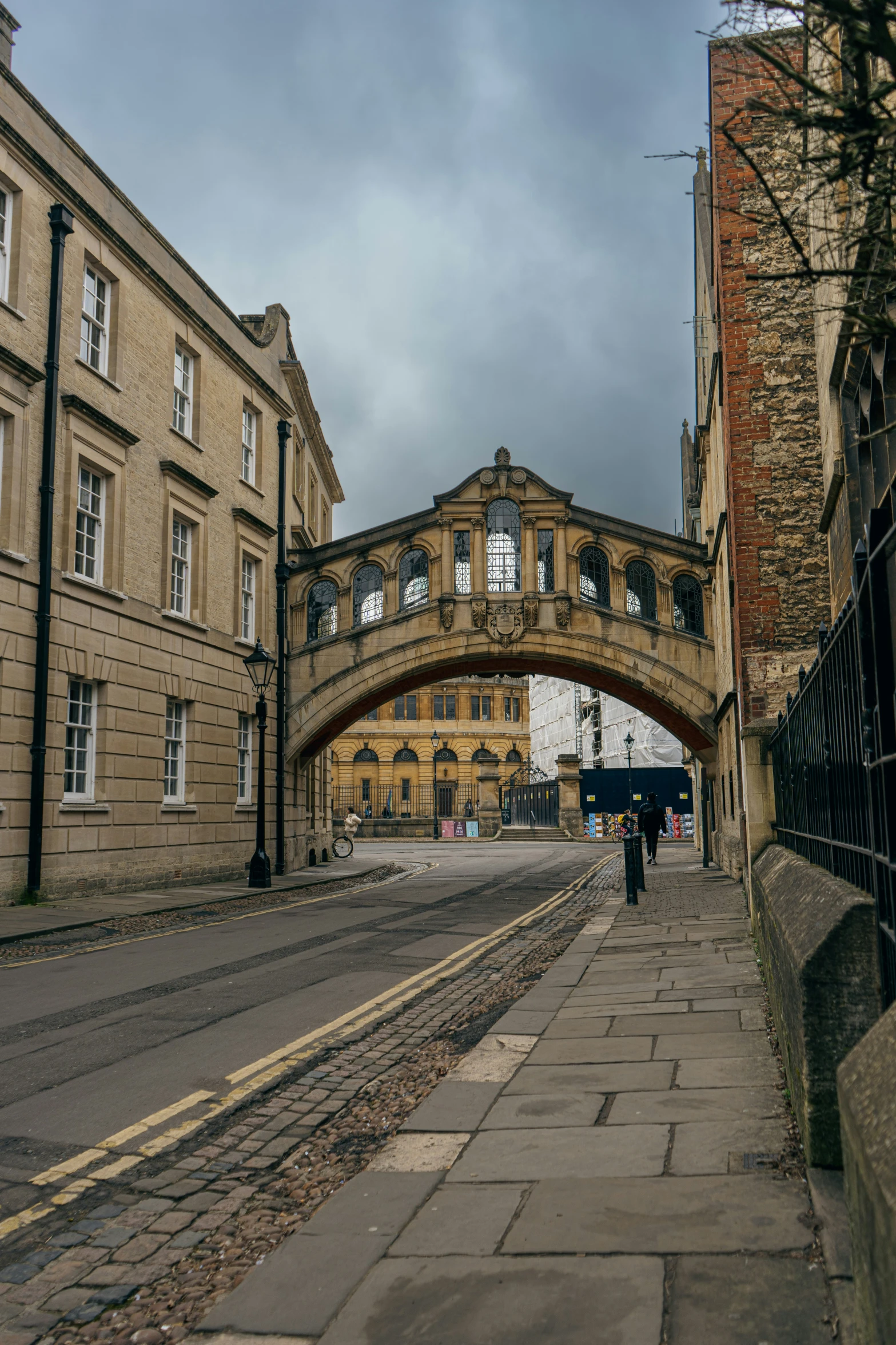 a view of a very old stone bridge that is going over some buildings