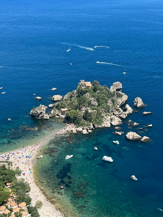 an island is pictured in this aerial s with boats coming into and off the shore