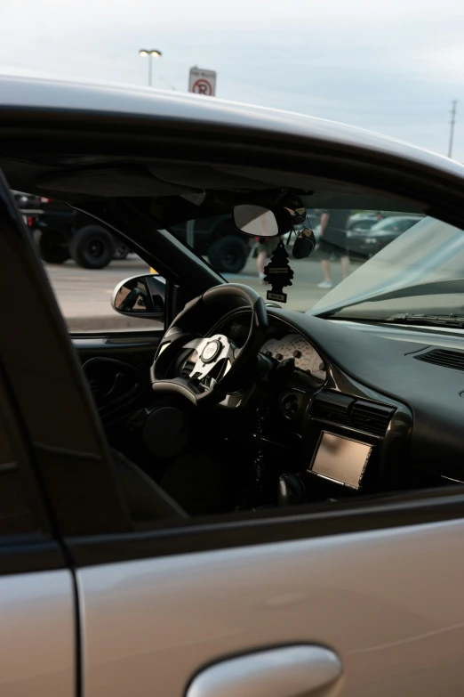 the steering wheel of a car, seen through a broken windshield