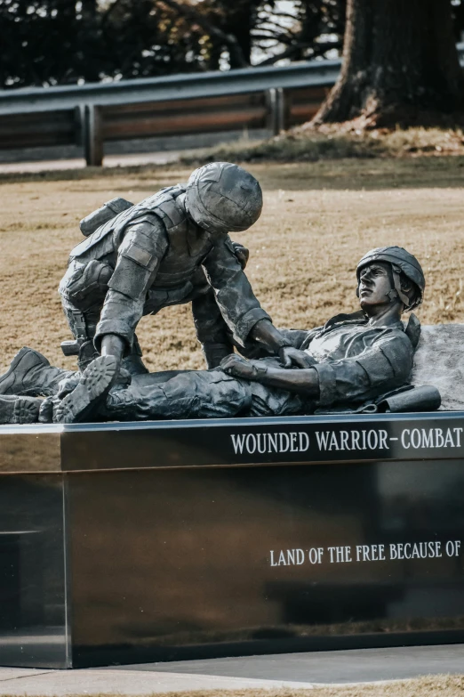 this is a statue of an army man laying on the ground