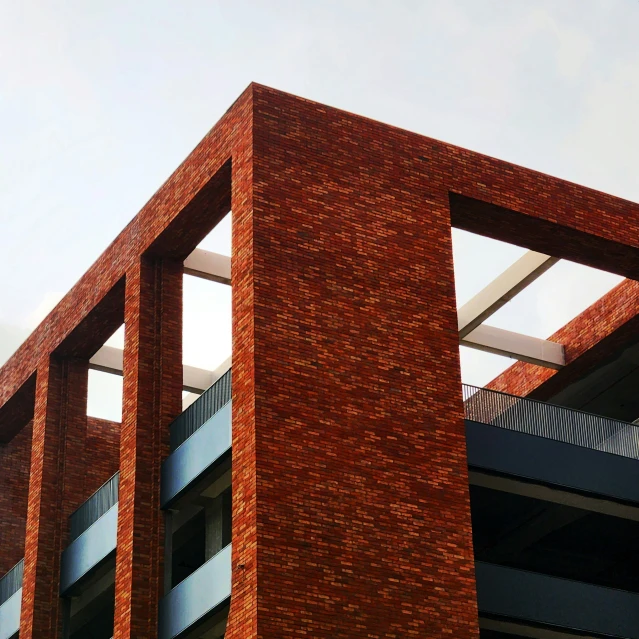 a large brick wall next to an office building