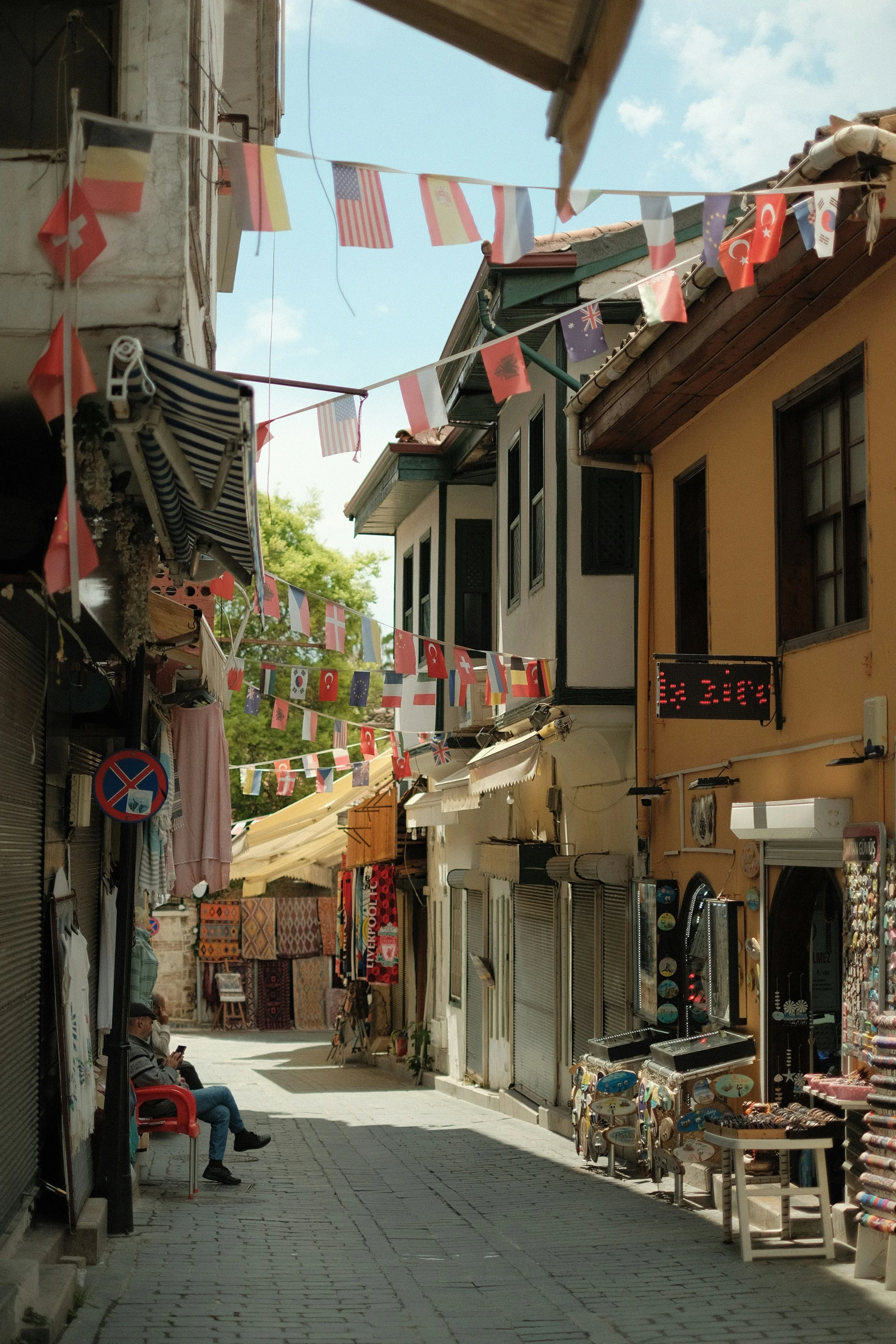 a street scene in a city with flags hanging in the air