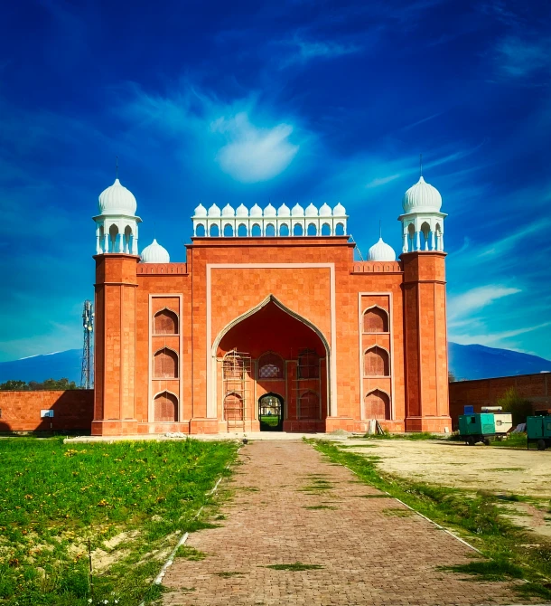 a large red brick building with two turrets