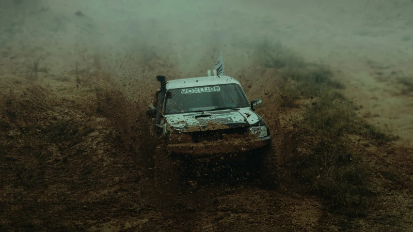 a vehicle is moving through some muddy dirt