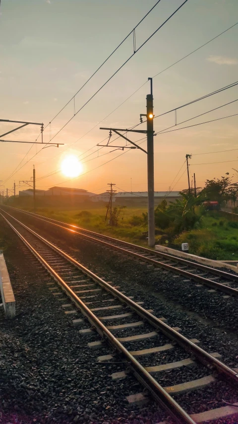 a train is sitting on the tracks in a rural setting