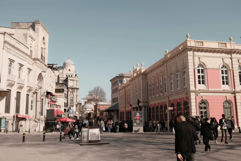 a view down an empty street as people walk around