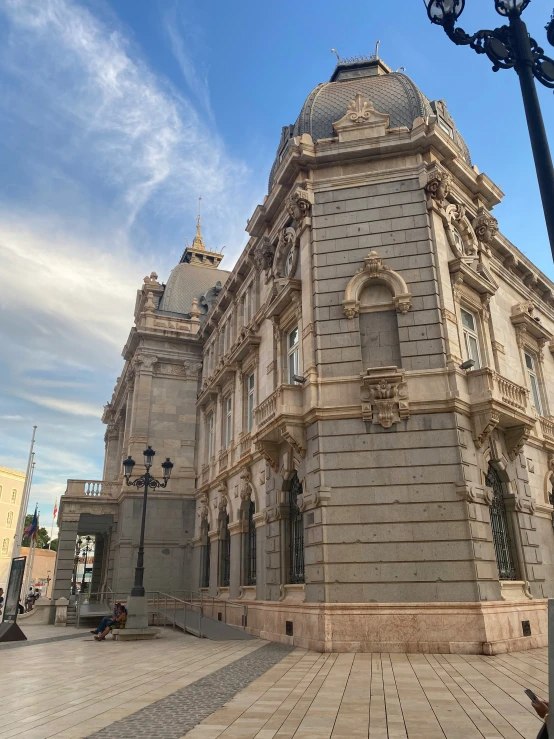 a building on an old city square in front of an ornamental lightpost