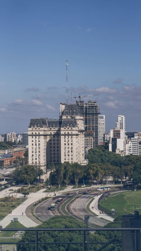 a city with a bunch of big buildings and trees in the foreground